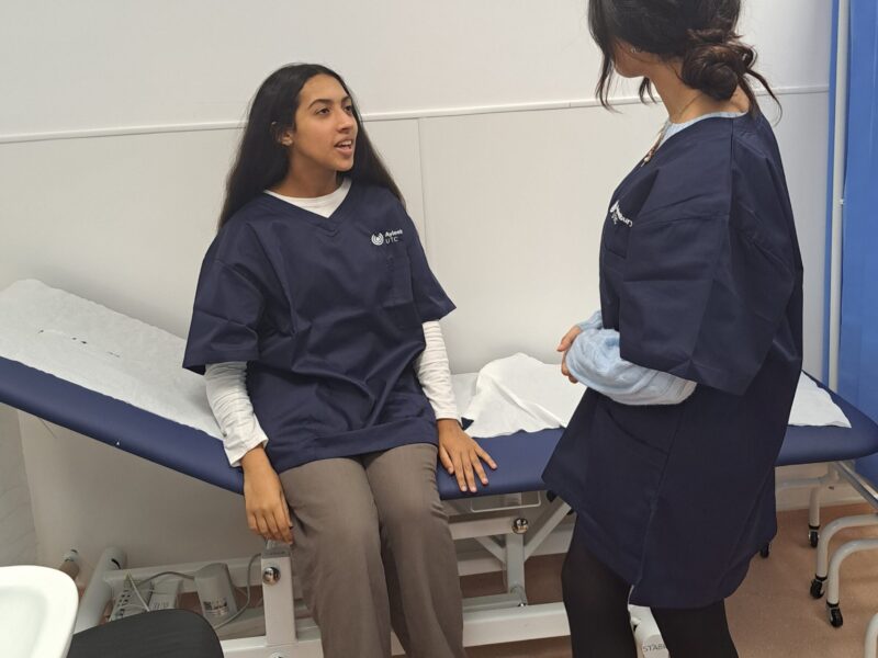 AUTC Health Students in Occupational Health practical wearing AUTC navy Scrub top